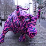 Polish artist Olek covered the Wall Street Bull in crochet as part of a guerilla street art piece.