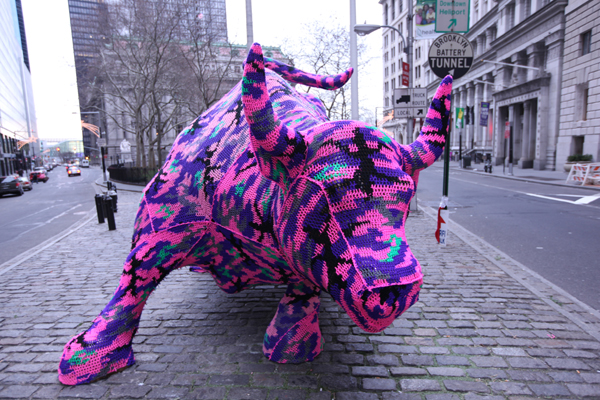 Polish artist Olek covered the Wall Street Bull in crochet as part of a guerilla street art piece.