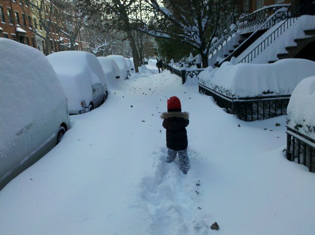 A child trudges through knee-deep snow in New York City after the December 2010 blizzard.